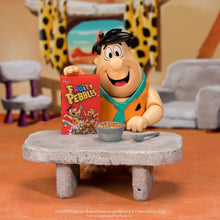 Load image into Gallery viewer, abba-Dabba-Doo ! Bring a taste of Bedrock breakfast nostalgia to your collection with the Fruity Pebbles Fred Flintstone 1:12 Scale Action Figure by Jada Toys! This highly detailed collectible captures everyone's favorite Stone Age dad, Fred Flintstone, ready to start the day with a bowl of delicious Fruity Pebbles. Expertly crafted in 1:12 scale, this figure perfectly recreates Fred's signature orange-spotted tunic, cheerful grin, and larger-than-life personality. With premium articulation, collectors can